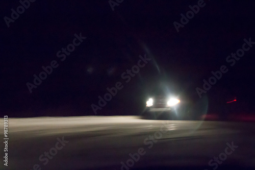 Fényképezés  Headlights on a car, winter driving in the dark
