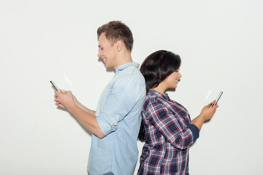 Pretty young couple is busy with modern technology