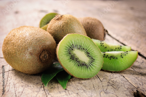 Fotografie, Tablou Kiwi fruit on brown wooden background