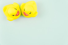 Pair Of Yellow Rubber Ducks Isolated Over Colorful Light Blue Background, Love Concept