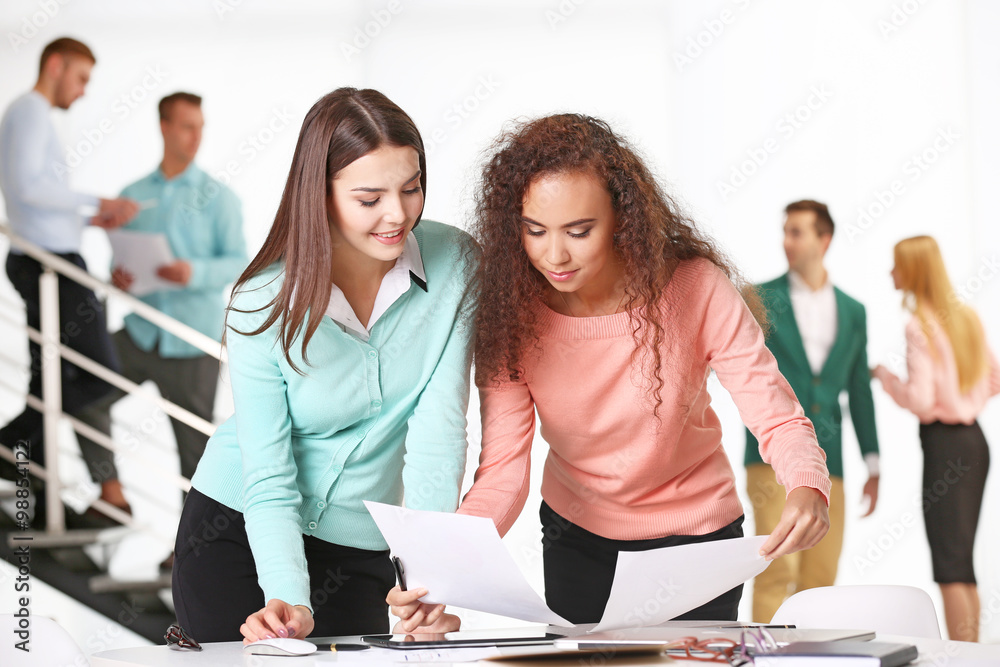 Two businesswomen working in a conference room