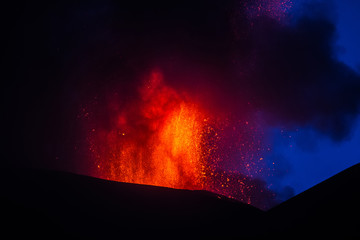 Volcano eruption. Mount Etna erupting from the crater Voragine
