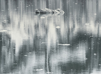 Wall Mural - Small Ice formation and mountain reflection in water