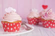 Pink Valentine cupcakes on a rustic table