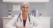 © Mark Adams - Smiling attractive mature female doctor talking to camera patient POV