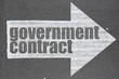 Arrow on asphalt road written word government contract