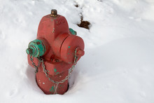 Red And Green Fire Hydrant In The Snow