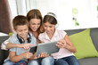 © goodluz - Mother with kids playing with digital tablet
