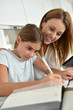 © goodluz - Mom helping daughter with homework
