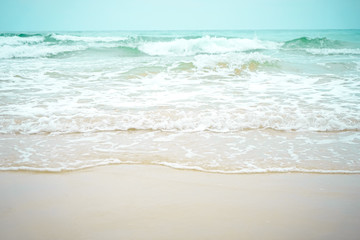 Sea waves flowing into white beach