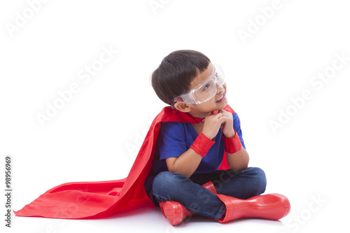 boy pretending to be a superhero with looking up on white background Poster