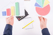 © Viacheslav Yakobchuk - Male hands holding two coloured graphs.