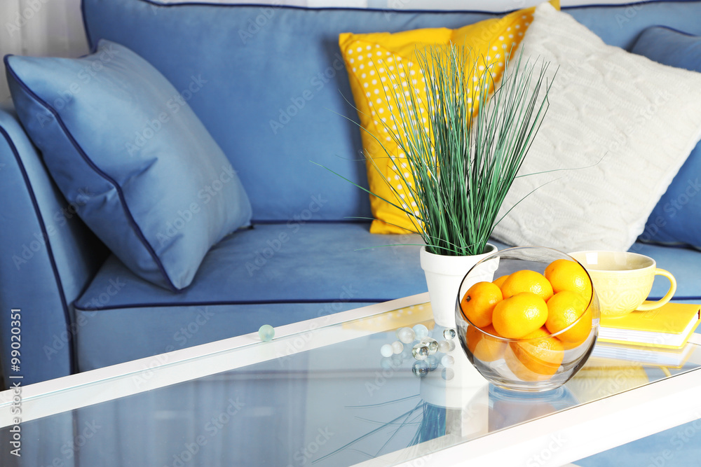 Bowl with fresh tangerines on table in living room, close up