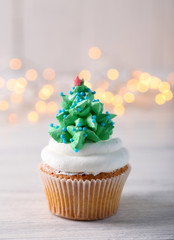 Poster - Christmas cupcake with lights on background