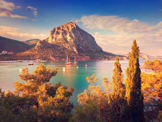 Wall Mural - Beautiful summer sunset at the sea with mountains and trees
