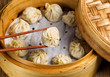 Freshly steamed Chinese dumplings out of bamboo steamer 