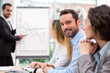 © Production Perig - Young attractive businessman working at the office with associat