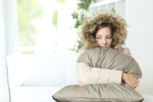 Woman Warmly Clothed In A Cold Home