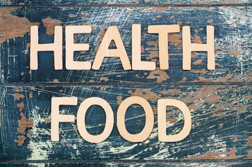 Wall Mural - Health food written with wooden letters on rustic surface
