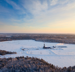 Wall Mural - Winter terrain with oil rig in winter, top view