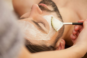 Cheerful guy is attending beauty salon