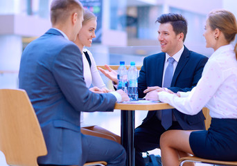 Wall Mural - Group of happy young business people in a meeting at office