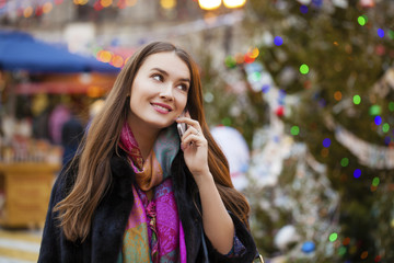 Wall Mural - Happy beautiful girl calling by phone