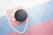 old hockey puck is on the ice with slovakia flag