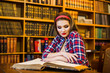 © F8  \ Suport Ukraine - Education school concept. Clever female student hair ponytail girl  sitting  in  library with  books. Indoor