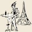 Fashion girl with glass of red wine sitting in cafe near Eiffel Tower