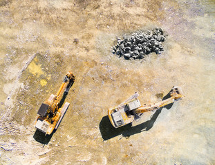Wall Mural - Aerial view of working excavators in the opencast mine. Camera flight over industrial landscape. Use drones to inspect of mining area. Technology theme.