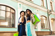 © Sergey Novikov - Happy young women shopping and carry bags