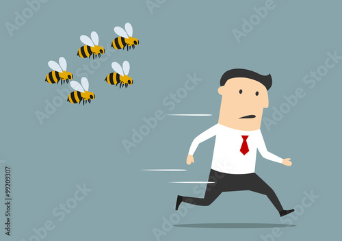 Businessman running away from angry bees