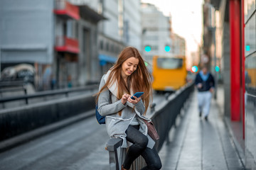 Woman with phone in the city