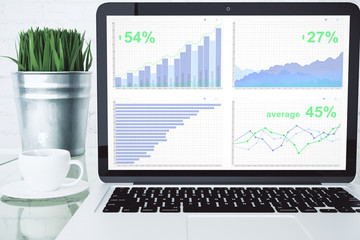 Poster - Business chart on laptop desktop with cup of coffee and green gr
