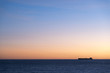 Silhouette  of cargo ship on the horizon