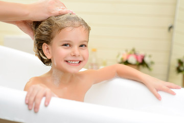 cute little girl washing her hair