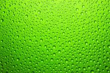Green Water Drops On Glass Surface Texture.