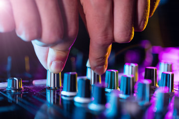 DJ turntable console mixer controlling with two hands