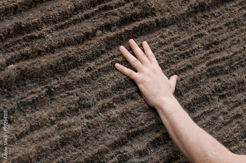 Fotografie, Obraz Hand on Geological sandstone rock formation in cape verde