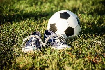 Ragged sneakers with a soccer ball