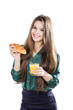 Young woman with glass of juice and croissant