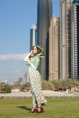 Wall Mural - Smiling girl in hijab covering her eyes with happiness in Dubai Marina