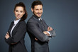 © ZoomTeam - Business couple on blue background