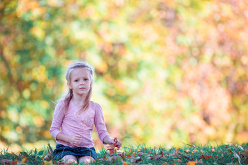 Wall Mural - Adorable little girl outdoors at beautiful autumn day