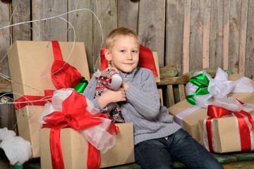 child with Christmas gift in hands.