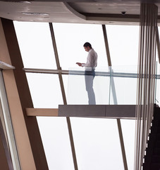 Wall Mural - young successful business man in penthouse apartment working on