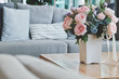 Beautiful Pink rose in vase on table in living room.