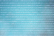 Grunge textured binary numbers code information on abstract grunge blurred cyan blue color background. Background with binary data and grunge cyan blue colored illustration background.