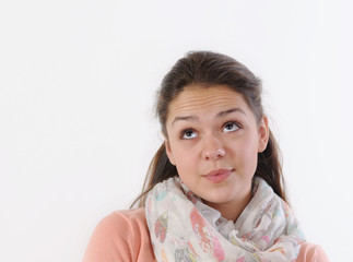 emotional portrait of cute girl looking up on white background